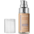 A pump bottle of Revlon Illuminance Liquid Foundation in the shade Tan Sand, with the cap removed.